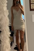 I wore this dress for my graduation photos. It is so cute and fun! I am 5'10 and ordered a small. It was a little short on me (obviously) but surprisingly a little baggy around the waist/hips area. First pic is when I first tried it on. I wanted it to be a little more form fitting, so I ended up getting it tailored (second photo). The lace is so beautiful. Like others have said, the neckline/front area is a little loose so you might have to end up pinning it if you want it to be more closed. Overall very cute dress; if you're tall make sure to wear spandex underneath or consider ordering a size up. - Emma P.
