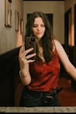 I'm a working Musician, so I'm always looking for "show clothes" and this top is absolutely gorgeous. I got so many compliments the first time wearing it! I even spilled coffee all over it a few hours before, took a damp cloth to it, hit it with the blow dryer and it was good as new! The color is a deep rich red, which is stunning, and the silky fabric makes it look expensive. Definitely recommend! - Andrea Y.