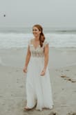 This dress received so many compliments! I bought it once I realized we were going to have some beach play at the wedding. The color is clean, the top was just beautiful and the skirt is heavy and flowy. I got it tailored to have no train but definitely could have! It photographed beautifully and I couldn't be happier. I ordered a 4 and a 6 just to be sure I Was giving it a good shot and the 4 was what fit. I'm a 36B/34C, BUST - 34.5 - WAIST - 27.5 - HIPS - 38.5. I highly recommend; it was such a great price for the dress quality. - Danielle L.