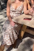 I bought this dress for wine tasting and it was gorgeous! Unfortunately I had to buy a medium (I always buy small at lulus) but felt okay but some reviews said it ran a little small. It was definitely too big, but I was able to manage because of the adjustable straps. FYI if you have big boobs this is not the dress for you, I was definitely adjusting all day. However, everything else was great about it and it was very high quality feeling. 
The knot in front did not bother me at all which a lot of other reviews mention. - Annie M.