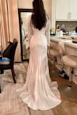 I got this for my wedding in July, I wanted a modest, long sleeve dress to cover up my sleeve tattoos that was not lace. This has some decent stretch and the material is good quality. It was a bit long, I kept tripping during my practice runs so I had it hemmed about 2-3 inches and it just barely hits the floor now. I have an athletic body type (wide shoulders/back, small waist/hip) and this really accentuates any imperfections you have so if you want something that is more forgiving this might not be the dress for you. Photo is before alterations. - Anna G.