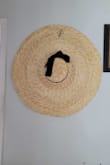 So I am a sucker for hats, especially big, floppy, sun hats. The bigger, the better! So when I saw this hat, I had to get it!!! This is by far the biggest sun hat I own (the brim is 11 inches wide!!) and I love it!!!! It will be perfect for when I go to the beach next month!!!!

I included a picture of it hanging on my wall, to give an idea of how massive this is lol (the black thing near the top edge of the brim is the tag). - Jessy C.