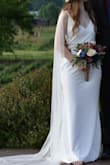 My wedding dress! I got so many compliments on this dress and my wallet is breathing a sigh of relief that I didn't have to spend hundreds or thousands. Paired it with a cape veil and a thin crystal belt and it was perfect. Oh so comfortable, and really sturdy, quality material for the price! The cape veil hid the adjustable straps but you can always have these permanently sewn in the the right height by a tailor if you don't have a cape. Low quality pic is before alterations. For the wedding I had these alterations: the top pulled in to fit more tightly and the dress shortened in the front so I could walk. Before alterations the bottom did fit perfect while the top was a bit too loose on my bust (I'm a classic pear shape). I also bought the small, which fit me perfectly on the bust, but was too tight for my comfort on my butt and abdominal area (you could see everything due to tightness there). So pleased with this dress!!! - Elizabeth R.