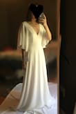 I love this dress, it drapes beautifully, and the flutter sleeves made me feel angelic. Great quality, especially for the price. XS fit me perfectly (with the exception of length, but I'm short). The dress is a bit heavy, so it might feel hot in the summer. I nearly picked this as my wedding dress! I just decided I would rather have a lacy dress instead. - Kristina H.