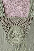 I like the way this shawl moves in the breeze. The majority of the fringes survived the first machine wash in a garment bag.

The entire shawl and a close up of the design on the back are pictured. - Amber B.
