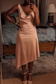 Wore this unique dress to a pink-themed wedding. It's beautiful, and the style of the back of the dress is very sexy. It was also quite comfy. Got a boatload of compliments! My only (extremely minor) complaint was how wrinkled it got throughout the night. However I think that's just the nature of the material. I definitely recommend. The sizing was perfect for me. - CELES C.