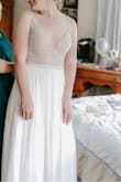 My original wedding dress didn't fit anymore and honestly I didn't really love it either. I had been eyeing this one for months and finally bit the bullet. It's GORGEOUS. It fit me perfectly and the detailing on the top is beautiful and looked so sparkly in the sunlight. I didn't need a bra which was great. The straps were a little itchy with the jewels but not anything too bad! - Mary C.