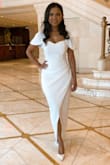 I am a petite person. 5'1. The dress is stunning and I wore it for my bridal shower. However, I had to pay extra to cut 4 inches off the bottom to make it a suitable length for me. It's made for tall people. A petite size would be great. The overall fit was perfect for my body but the length was super long. Overall satisfied with the dress & if you don't mind altering to fit your height, I recommend it. - Fahima Y.