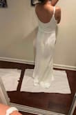 I am normally an XS in lulus dresses, they only had a small left in this dress and I ordered it just in case. In the pictures the dress is too big just in the chest area (even with the adjustable straps). I had a material gap between my armpit and chest. Everything else fit just like an XS, I'm sure the Xs would have fit me better all around. There is a sewn line on each side of the boob that I'm not a fan of. I'm wearing 3-4in ish heels and I'm 5'1, dress is still too long on me. 
Excuse me standing on paper, as I was trying to keep the dresses clean from any cat hair on the ground. - Nicole T.
