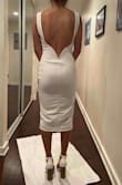 Great dress/form fitting! However, in my opinion it looks too much like a dress to wear in the office but has the back of a party dress. It's a weird combo, but if that is what you're going for then it's a good dress!! I loveeee the back but the front throws it off for me. 
Excuse me standing on paper, as I was trying to keep the dresses I was trying on clean from any cat hair on the ground. - Nicole T.