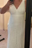 This dress is classic, simple, and elegant. The material is very soft, and the feathery tufts at the neckline did not even touch my skin. I ordered it with several others, and ultimately decided on a different dress, but this was a very close second. Exactly true to size (I'm a 12-14 in street clothes). Looks like it would be very easy to hem to desired length, and it is long enough to wear with sky-high heels if you wanted to. - Amber R.