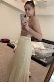 The skirt is definitely cream, so don't get your hopes up that it's a white-ish cream, it's just a yellow-y cream color. Also, the material is pretty stiff and a little noisy. Doesn't have as much movement as it looks to have in the photo. It's really not a terrible skirt, it's just not for me. 
Sizing: I usually wear a medium but sometimes can go down to a small in skirts, but this medium was loose on me. I'm not sure I'd trust going down to a size small, but it did just feel loose around the waist. 

I am returning it. - Shaelyn F.