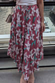 I love this skirt. Following reviews here, I went with the XS, since I'm short and the waist is elastic. It fits great and stays up without feeling constricted. The fabric is so light, and flows when you walk if there's any breeze-- felt so epic going down the stairs! The slits make it even more airy and fun, and they don't go too high so you can definitely wear bike shorts or shapewear under. This skirt looks and feels great on, can't recommend enough! - Monica A.