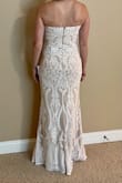 Didn't wrinkle in shipping, so I expect it will travel easily for a destination event.  I usually wear a 4/small, but definitely needed the medium in this dress. Length is perfect with 2.5" heels. - Lisa M.