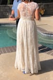 I love this dress so so much, it was so perfect for my casual courthouse wedding! I got TONS of compliments, and I felt so confident and beautiful. I ordered a S. It was SUPER long, but I got it hemmed. I also got it altered in the shoulders to sit better on my chest because of the low V cut. I am small breasted, so the amount of chest showing was fine for me! The back of the dress it absolutely stunning. I loved the lace, the shape and the buttons! Classic, simple, and elegant. I would buy this dress a million times over even if I had an unlimited budget! I highly recommend alterations to make the fit extra perfect for your specific body type. - Charisse M.