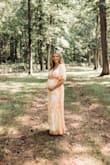 Bought this dress for our maternity shoot. I sized up to a medium based on the other comments/reviews and the dress fit perfectly with a bump! I wore at 34 weeks about 160 lbs. The dress had a bit of stretch & super comfy. I'd say non maternity this dress would have been way too big. - Erika F.