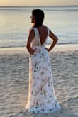 This dress photographed like a dream and exactly as pictured on the site. The quality of the material was stellar. The fit was true to size on the size chart but keep in mind there's not much give on the waist measurement. There is room to go up on the bust measurement.  I am 5'3" so Lulus maxi dresses are always long on me and I have to wear 3" heals to make them work or get them hemmed. 
Overall, I'm very happy and would buy it over again. This dress gives off a beautiful feminine vibe! - Rosa C.