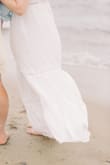 This dress was just what I was looking for for our beach engagement photos! It flowed beautifully in the wind. If I wore it out, I would definitely have to wear a heel and the top button was struggling a bit to keep the girls in but it doesn't feel tight around the chest area. - Madison P.