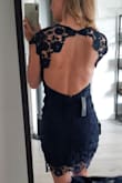 I originally bought this dress in white lace for my engagement party and loved it so much I bought it again in the navy blue so I can wear it for other occasions. It fits amazing and the lace is so beautiful. - Anita I.
