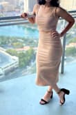 Bought this dress for a recent trip to Las Vegas. I really wanted the black, but they were sold out in my size so I went for the nude. I was a little nervous about how it would look with my skin tone, but I think it worked really well and I felt amazing. I'm 5'3" and the skirt was maybe a little longer than I'd ideally have a midi length be, but the slit was really nice. The quality of the material was honestly really great too. - Sarah M.