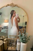 This dress is my Catholic ceremony dress for my wedding! It's so beautiful and elegant. It has a tighter fit which I like, and is a thick material. Obsessed with the low back and button details! I will need spanx for the tummy area but it would be fine without too. 10/10 you need this for your big day! - Natalie K.