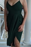 This dress fit me perfectly. I honestly can't remember the last time I comfortably wore a dress without a bra -- with a 34D, that's just not my lifestyle -- but this one worked! It was perfectly tight in the bust, i.e., tight enough to provide support but not too tight so as to be uncomfortable. (I didn't wear petals or an adhesive bra but was assured the material was thick enough that I didn't need to.) The green color is a bit darker than it looks on the model which I thought made it look even classier. I wore it for a wedding rehearsal dinner and felt both elegant and subtly sexy. I wore my hair down with simple jewelry and black strappy heels (those shoes pictured). The only downside is that we were outside in hot humidity, and I think sweat showed through in the back of the dress. Now to hand wash it so I can wear it again! - Christine F.