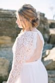 This dress was perfect for my Covid 2020 elopement November wedding. We had a small ceremony in Texas at a rock cliff lake and the details in the dress stood out perfectly. The details on the sleeve and the back of the dress were to die for. I loved how stunning the lace was and it was exactly what I was wanting. I am a little small chested and so getting a size large, made the top a bit too large, but I had double-sided body tape to stick it down so my boobs would not peep due to the wind. It worked perfectly fine! I highly recommend this dress for anyone who is having a small ceremony or one by the waterfront in the winter! - Kimberlyn B.