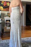 This dress is absolutely gorgeous, but it runs very small in the bust. I had to order up two sizes to even get it zipped up all the way! It looks great on, very flattering, and is very long, so would definitely need hemming. I'm fairly tall, and wearing 2 1/2 in heels in the photo, and it is still puddling on the floor. The sequins scratched me up pretty badly just while trying it on, so I don't think I could survive wearing this dress all day. I ultimately chose a different Lulus dress, that is almost identical, but without the sequins. - Debbie S.