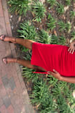 This is the third Time I have ordered a dress from Lulus and they never miss. The material is stretchy and the dress has a lining so you can't see through the dress. The picture of the model is accurate to wear the slit goes up to, mid thigh. It's sexy but not risqué. The red is a little darker in person. It fit a little snug but I wouldn't have sized up (it would be nice if they did carry some dresses larger than an xl though). I'm wearing lightly shaping shape wear in this picture. - Carmen S.