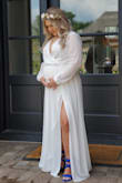 I got married in this dress at 19 weeks pregnant and it was a dream. I felt like a goddess in this dress. I ordered my pre-pregnancy size and it fit perfectly but if I was not  pregnant it would have been too big so I would definitely size down. I'm short so the length needed to be hemmed but the sleeves were also a bit long so we hemmed them as well. It comes a bit wrinkled because of the material but nothing a home steamer couldn't fix. 1000% recommend! - Amanda L.