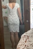 This dress is really pretty! The white part is super soft and the nude underlay is a silkier material. It's form fitting but comfortable. The webbing between the leaves feels delicate, so be careful of handling the dress when you're not wearing it so it doesn't snag on other hangers/clothes. The cut out in the back is really unique and flattering as well! The only part I'm trying to figure out is the seam that runs horizontally under the chest - it makes a visible bump on my dress, but I may just need to adjust the fabric after I put it on. - Mary H.