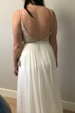 I have been eyeing this dress for a while. I figured for the price what do I have to lose? Worst case it's a dress that will travel easy to my east coast second reception. Best case I end up with a dress for less than $300CAD after taxes and duties.  It's beautiful and I would say better than similar David's Bridal Dress for $1100 CAD!  Order size down like all reviewers are saying. I would say I'm a size 6-8 usually and a have a big butt but the 4 fits (little tight around the chest but I'm up about 10lbs right now and i can still zip up) - Deanne C.