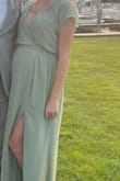 This dress was pretty and comfortable. I usually wear a size medium (when not pregnant) which is what I ordered because other reviews said the dress runs large so I felt confident this would fit well with my baby bump.  I was surprised with how large it still was. I wish I would have ordered a size down.  Even with my bump, it was large and I needed to use double sided dress tape to help it fit okay for the wedding. Otherwise, the dress was great, but I would recommend considering ordering at least 1 size down. - Melinda S.