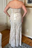 This is THE DRESS! The L fits perfectly, though the lining tends to bunch up just a bit. I am still losing weight, so I figure that will either resolve itself by my getting thinner, or by the fabric stretching a bit. It is a bit more beige than appears in the online photos, but since this is my second (and final!) wedding, I don't want a pure white dress, anyway. The length is absolutely perfect, and I won't need to have it hemmed at all. I am fairly tall, and am wearing 2 1/2 inch heels in the photo, and you can see my toes and a bit of the shoe. This dress is very flattering, lightweight and comfortable, and I feel beautiful in it, just like a bride should feel! I added a sparkly bridal sash from Amazon to complete the look (seen in my photos). Absolutely stunning! - Debbie S.