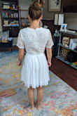 I was looking for a dress to wear to my rehearsal dinner in Texas and while the heat is still on, the sleeves were too much for me. Otherwise, it's a very conservative cut and fit. I am a small in most other Lulus dresses, but I sized down for this and it worked! The scalloped neckline is a fun detail as well as the scalloped sleeves! The sleeves may have bothered me just because of how thick the material is. - Randi N.