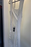 I loved the detail in the back but in real life it's very complicated to put it together. From the front it look like pajamas and is not flattering at all. It gets wrinkled so easy since the fabric is not the best quality. - Maria F.