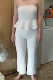 Firstly, what a convoluted process just to leave a review! I ordered this pantsuit to wear for my Bachelorette party. I tried it on and the first thing I noticed is how heavy the material was for something strapless. The material is very stretchy, which is comfortable, but the overall weight pulls the pantsuit down with every step. The girls popped out just walking across the room. The other glaring issue is the top has 2 layers of material which causes it to curl/fold under so the silicone grippy at the top rolls to the outside. That further compromises the integrity of the strapless top. The zipper is also very difficult to get past the ruffles; I required assistance just to zip/unzip (not ideal for a pantsuit that requires frequent zipping). Nextly, I ended up with a wedgy just to keep the girls covered. I can't go in public in this for fear of arrest related to public indecency. Don't bother with this unless you are bringing your breasts as party favors. - Emilee C.