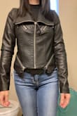 I've been looking for a fitted jacket like this and this is perfect. I read posted reviews and ordered a size up. I typically wear a size small. A medium fits perfectly for me. The arms would've been too tight if I ordered a small as it feels perfect in a medium. I don't think I could wear it with a sweater in the winter, but wore it with a knit material long sleeve shirt the other night and it was fine. You might want to go up two sizes if you want to feel more comfortable wearing any sweaters with the jacket. - Jung-yoon S.
