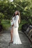 This dress is absolutely stunning in person and so flattering. 
I wore it at 8 months pregnant for my maternity pictures and it made me feel so beautiful. 
It hugs all the right places, and the material is gorgeous in person.

Highly recommend. Ordered the size 1X to fit over my bump and it was perfect. - Shirley F.