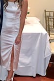 I bought this dress for my rehearsal dinner and was absolutely obsessed! It fits true to size, the slit is just the right length and the material is actually a little thick which I loved. It wasn't just like a silky slip material but actually has some stretch to it. Got so many compliments and will find a way to wear this again! - Michaela B.