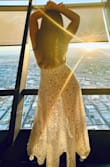 I would've worn this to my own wedding if I had seen it before. So, I ended up wearing it on my wedding anniversary in Vegas. With no exaggeration all eyes were on me when I walked in it in the lobby of one of the busiest and most luxurious hotels in Vegas. Buy it! 

It comes with a nude bodysuit which makes is super sexy without having to reveal much. It was a bit long for my height but I had it hemmed and used the extra fabric as a scarf to compliment the look. - Nataly R.