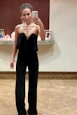 Loved this jumpsuit.. Wore it to a wedding and got so many compliments and even a few "you look so so hot!" from a few friends
of mine & it stayed up all night and I didn't wear any bra or anything.  It was fitted throughout the waist up to the ribs and bust and loose in the thighs and legs   It just was sexy and fun and amazing and while the other girls at my cousin's wedding all looked the same in their dresses I was the only one in this fun sexy fresh jumpsuit !! - Lindsey T.