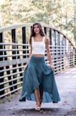 The high-low maxi skirt is made of a light-weight material that is easy to iron and beautiful to twirl! The sage green is a beautiful accent color for pictures and adds a classy yet earthy feel. Pictures courtesy of Lorinda West Photography. - Tricia M.
