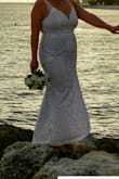 The dress is so beautiful and the length was perfect! I am 5'9" and a curvy size 14. The fabric is not quite as thick or stiff as I would have liked, so I wore spanx underneath to smooth my curves. It was perfect for my beach wedding. - 5 R.