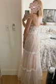 This dress is a dream in person. The materials, if made cheaply, could come across as costume-y but no, I'm always impressed with Lulus' quality for the price-point. The dress is beautiful.
I'm doing a very small backyard wedding and didn't want to spend a boat load of money on a wedding dress. I had kind of a picture of what I wanted for my dress, but based on the customer reviews for this dress got kind of excited and decided to try it and yeah, just loved it. I did read another review that said they wore a trumpet slip underneath, and I think I will do that too, as you can see the slip of the dress hugs the legs underneath. - Katina